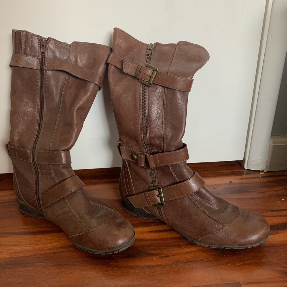 reddish leather boots with a buckled detail